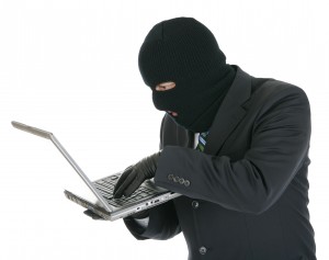 Computer criminal - Hacker with laptop computer